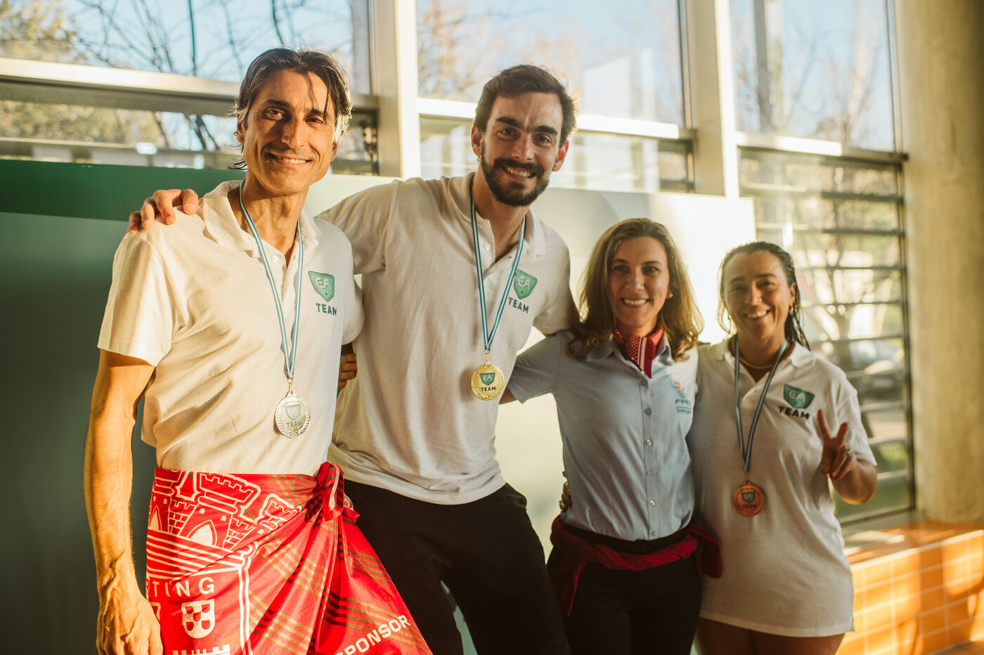 EA Team athletes smiling with medals at the ANEA Swimming Tournament