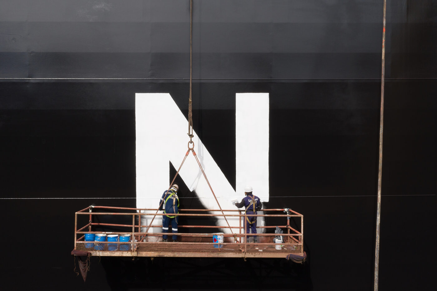 Painting the Tsakos Energy Navigation (TEN) owner's «N» logo on the ship's hull at the Lisnave dock